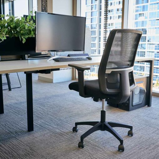 Bianca Mesh Chair at office desk with monitor and city views